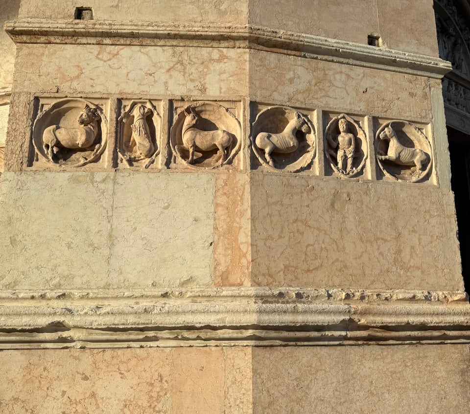 photo of relief carvings in marble wall of the San Giovanni Battista Baptistery by Antelami