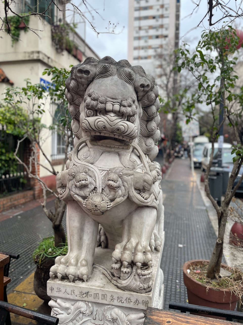 A Chinese marble lion statue stands guard at the entrance of Chinatown in Buenos Aires.