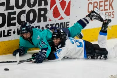 NY’s Bourbonnais dives for the puck with TOR’s Nurse 