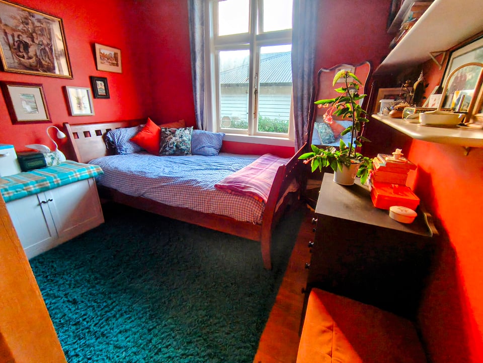 orange room with blue covered bed