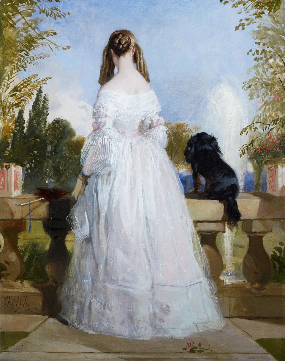 A portrait of a young woman in a white gown, standing on a verandah with a little black spaniel.