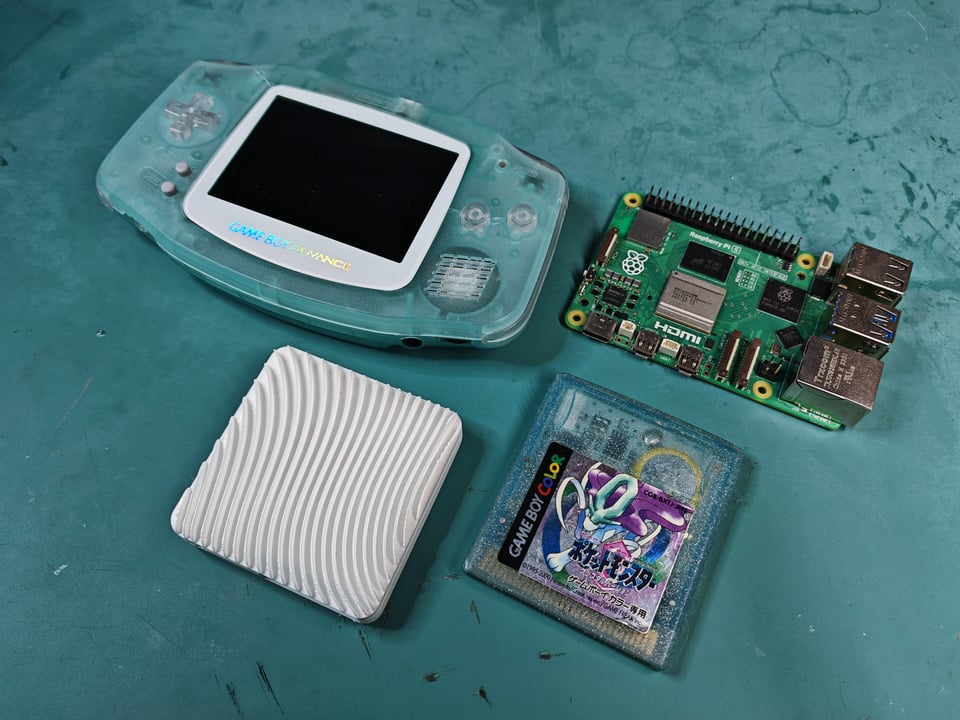 Kawaii system next to a Gameboy cartridge, Raspberry Pi, and Gameboy Advance
