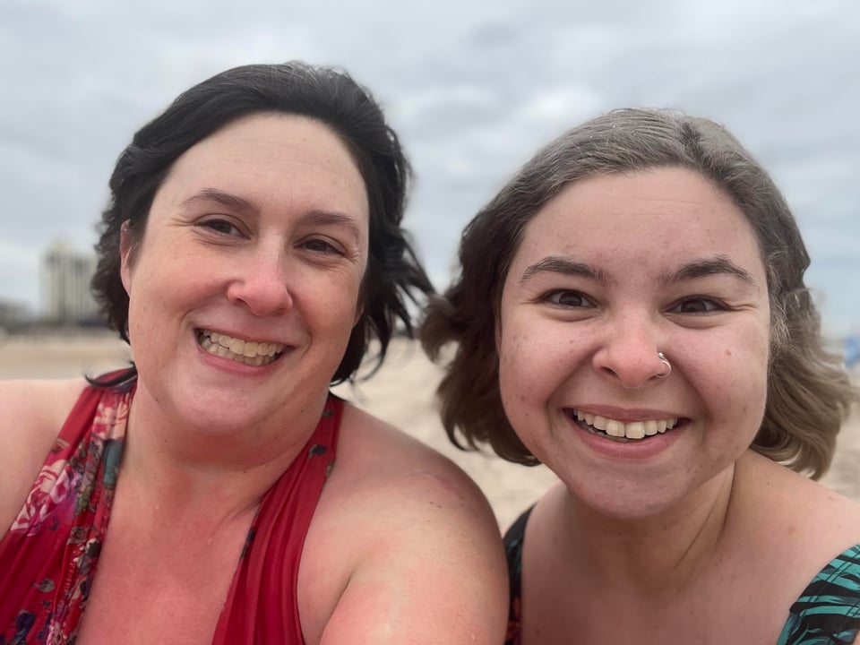 I'm on the left in a red suit and Fiona is on the right in a green-black suit, and we're smiling and wind-swept.
