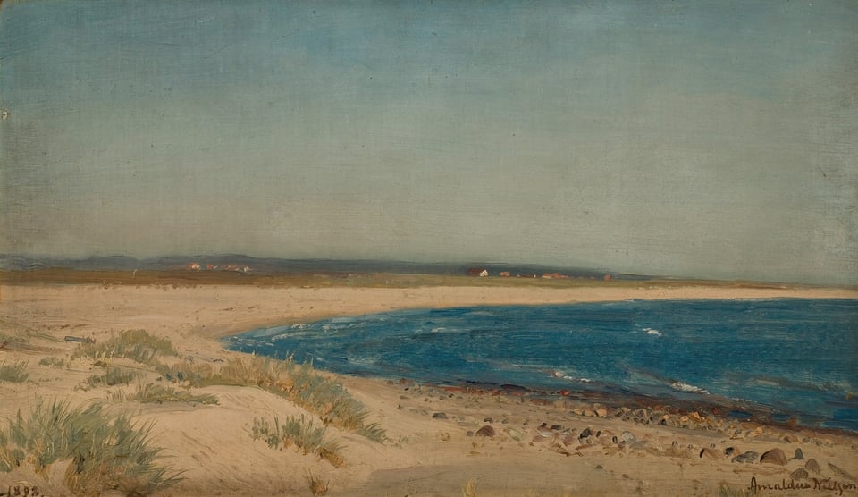 a yellow sand beach with a dark green and blue sea
