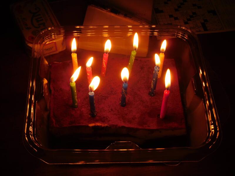 A small cake topped with lit candles