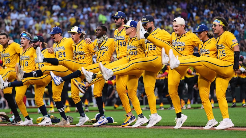 Promotional image for the Savannah Bananas baseball team. Shows a chorus line of men in bright yellow athletic uniforms doing the can-can.