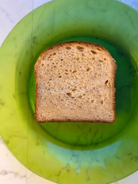 Image of slice of vegan brioche on a green plate