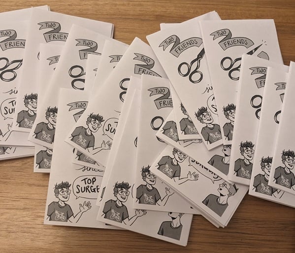 a pile of Maia and Liam's zine, titled "Two Friends, Two Years Since Top Surgery."