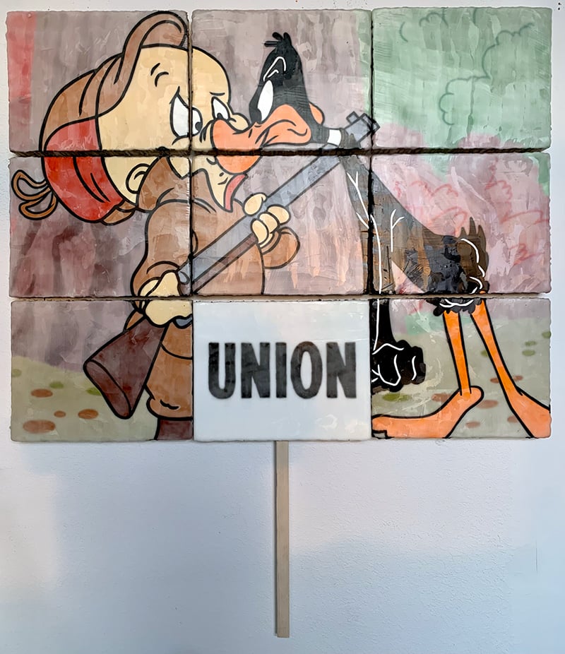 Daffy is telling Elmer Fudd what's up. There's a UNION sign.