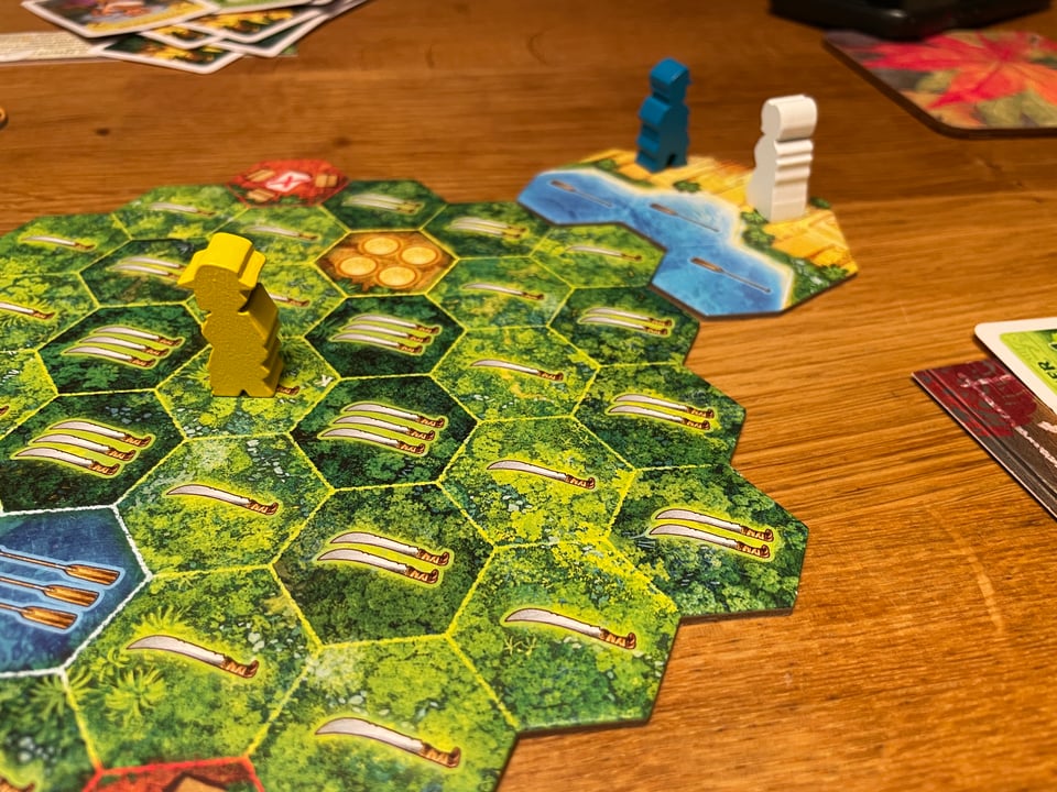 A close up of a board game "El dorado". Two pieces stand together at the end.