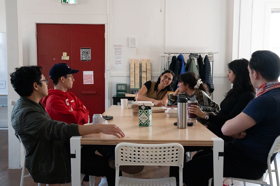 A group sitting about a table.