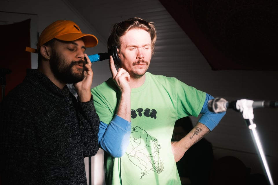 Kenny H and I sharing a pair of headphones and working out harmonies.