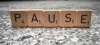 Scrabble tiles spelling the word Pause
