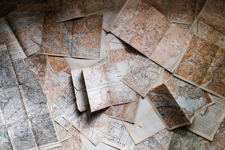 An image of maps scattered across a table.
