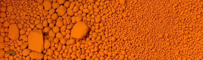 Close up of particles of red-orange pigment lead chromate basic