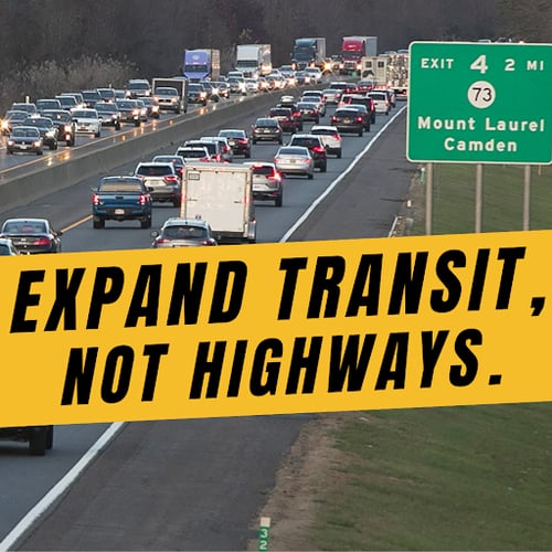a highway with a sign that says expand transit, not highways