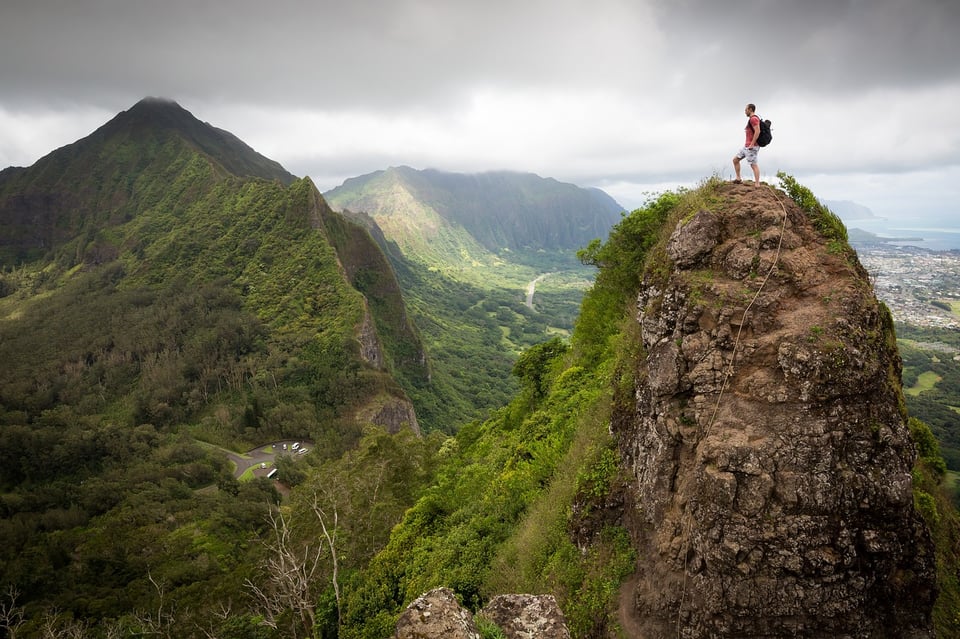 a man standing on top of a mountain.
