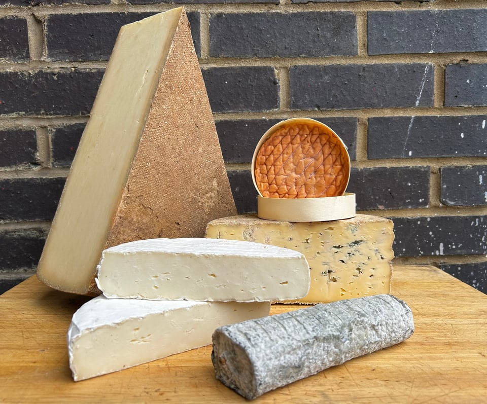 Clockwise from top-left - Templegall, Epoisses, Pevensey Blue, Sainte-Maure de Touraine and Scimudin cheeses