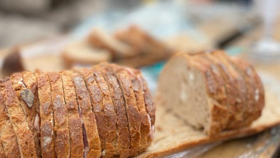 Picture of a 'surprise bread' sliced into little sandwiches and put back on its base.