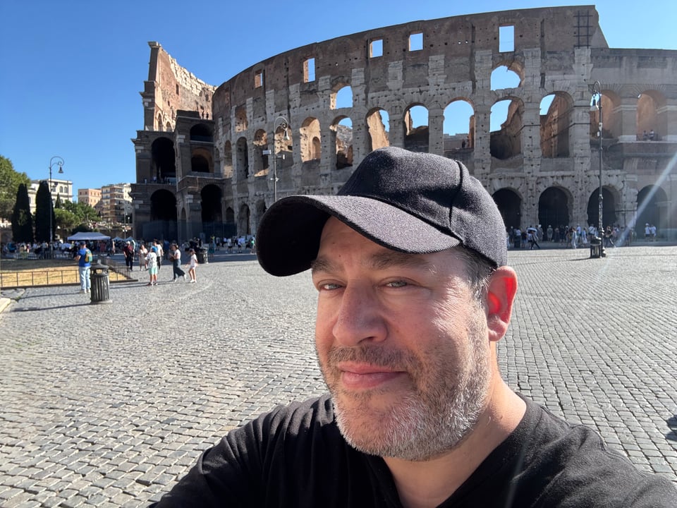 Neil standing in front of the Colosseum in Rome