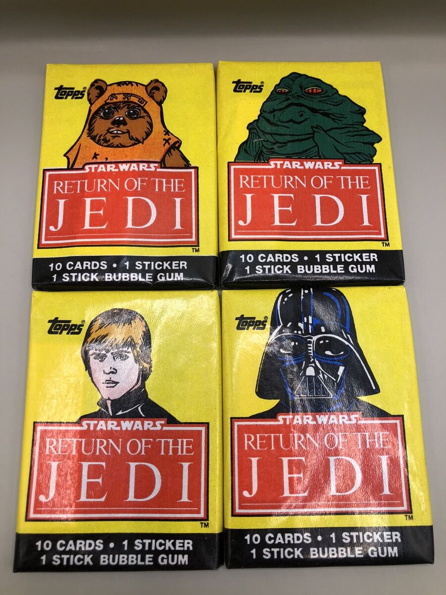 an image showing four yellow packs of return of the jedi trading cards from topps, feauring the movie logo in red and a different character on each - luke skywalker, an ewok, jabba the hutt and darth vader