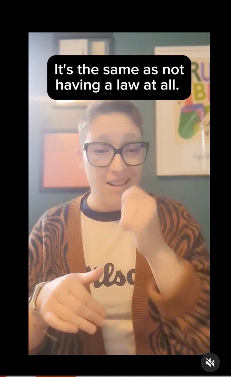 Image: Deaf author Sara Novic, wearing a cunning tiger-print cardigan,