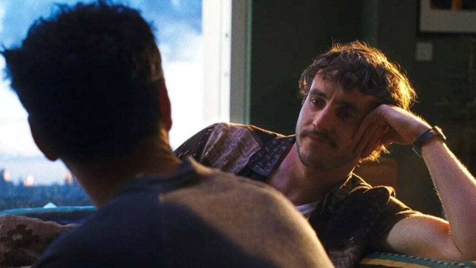 Paul Mescal looking longingly over Andrew Scott's shoulder with the London skyline in the background.