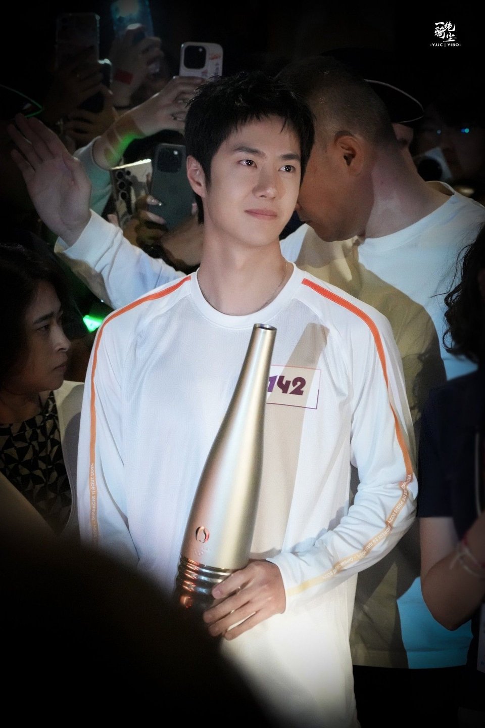 Our golden child wearing an expression of pride and happiness that i think we can call transcendent as he holds the Olympic torch in Paris