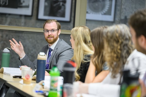 JMC Prof. Jordan Cash, speaking while gesturing with his hand during an Academy for Civic Education workshop.