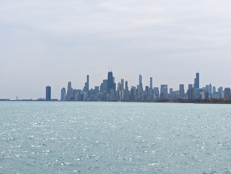 The downtown Chicago skyline, with Lake Michigan in front of it, seen from Montrose Point Bird Sanctuary