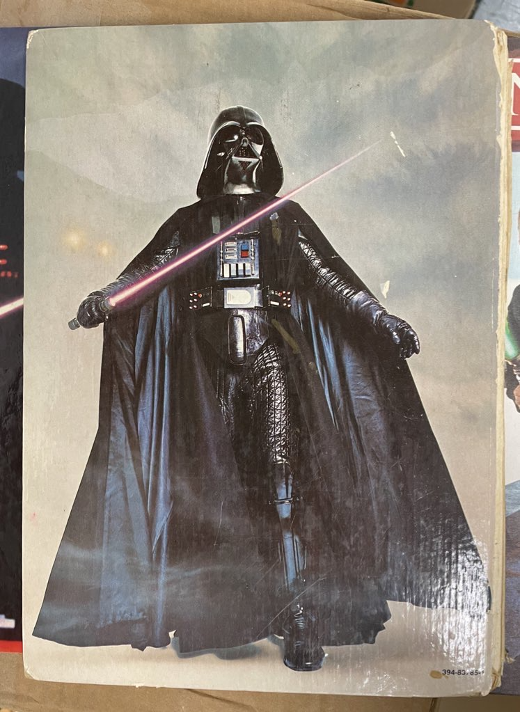 A 1970s photo of Darth Vader against a wispy family portrait backdrop