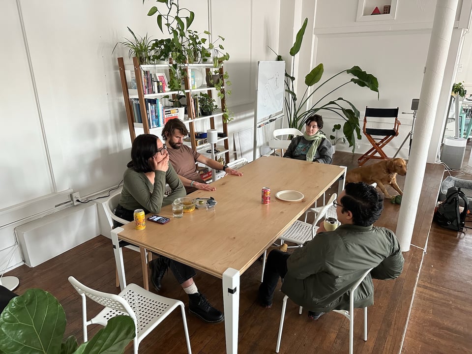 A different photo of people sitting around a table.