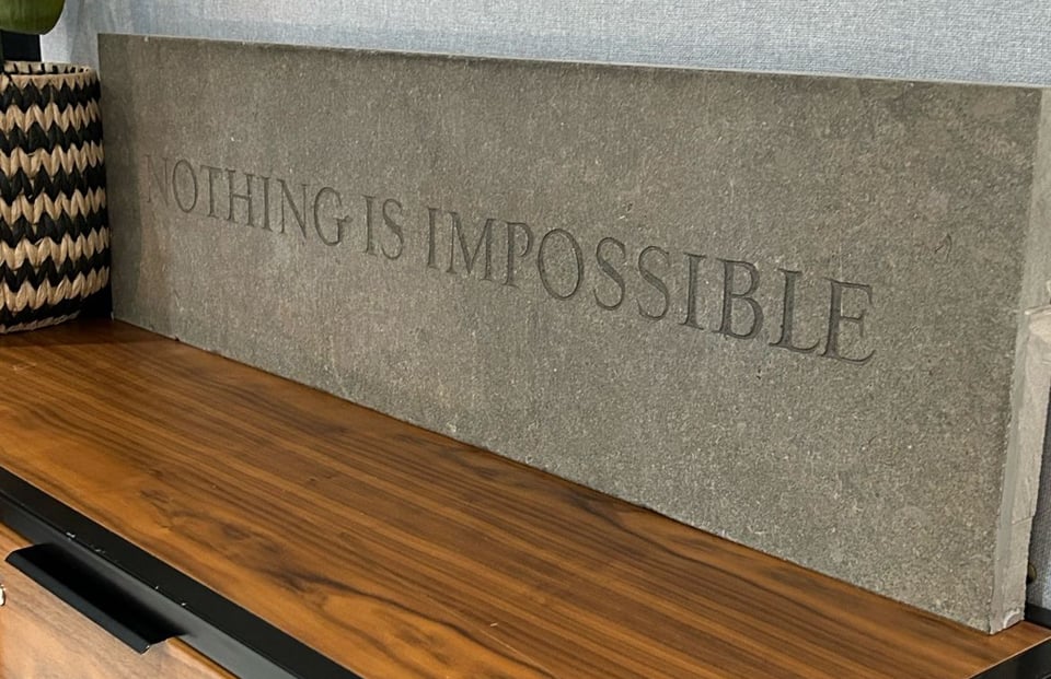 Photograph of a piece of stone into which the words, "NOTHING IS IMPOSSIBLE" have been engraved.