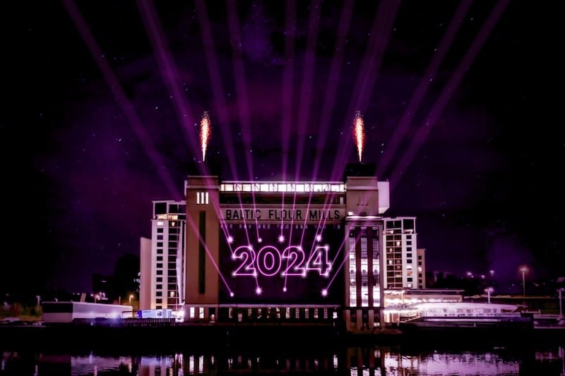 A CGI image of the Baltic art gallery on the banks of the Tyne in Newcastle. Lasers beam the image "2024" on to its facade.