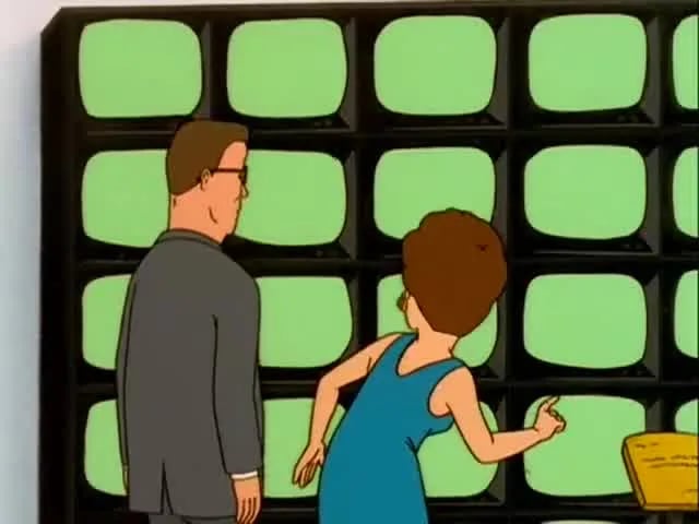 hank and peggy hill stood by a grid of green tv screens