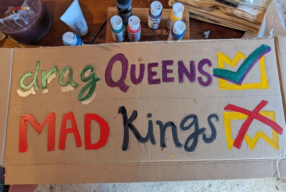 Protest sign reading "Drag queens, check! Mad kings, NO."