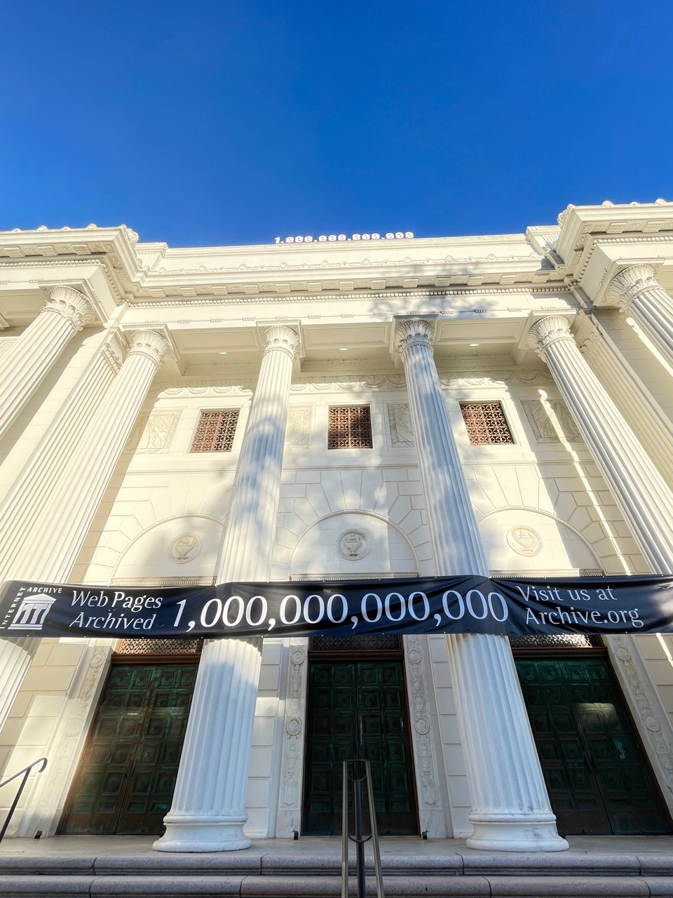 Facade of the Internet Archive Headquarters with a banner celebrating 1,000,000,000,000 web pages archived