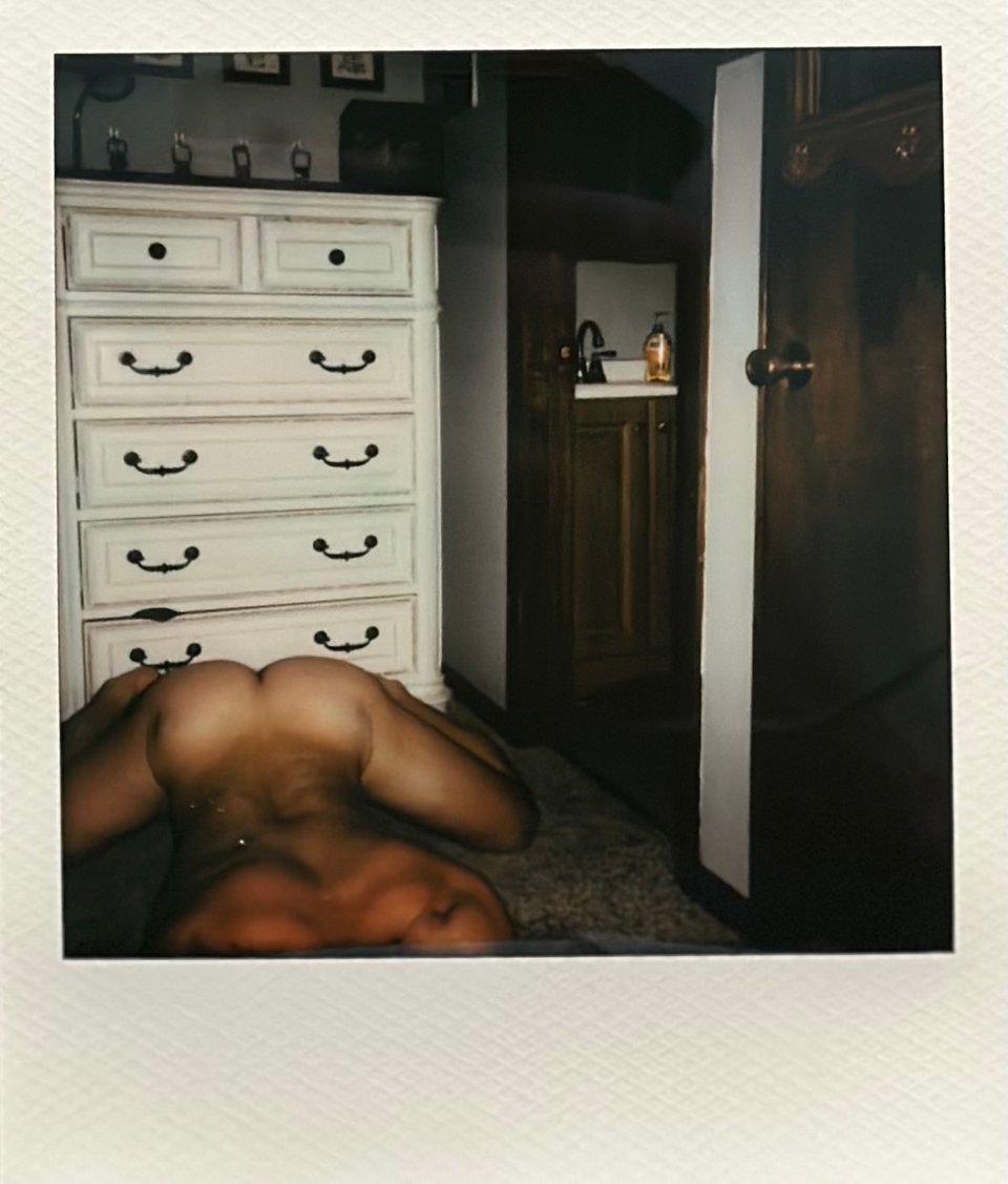 anonymous polaroid of naked man on carpet
