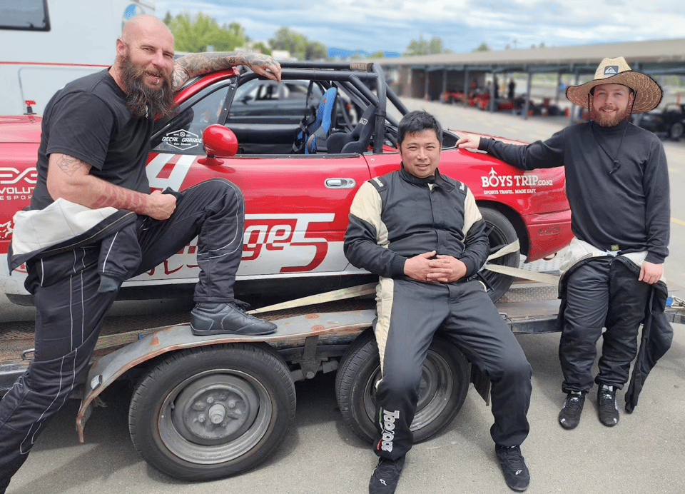Ayven Dunn and friends in front of an MX5 on a trailer