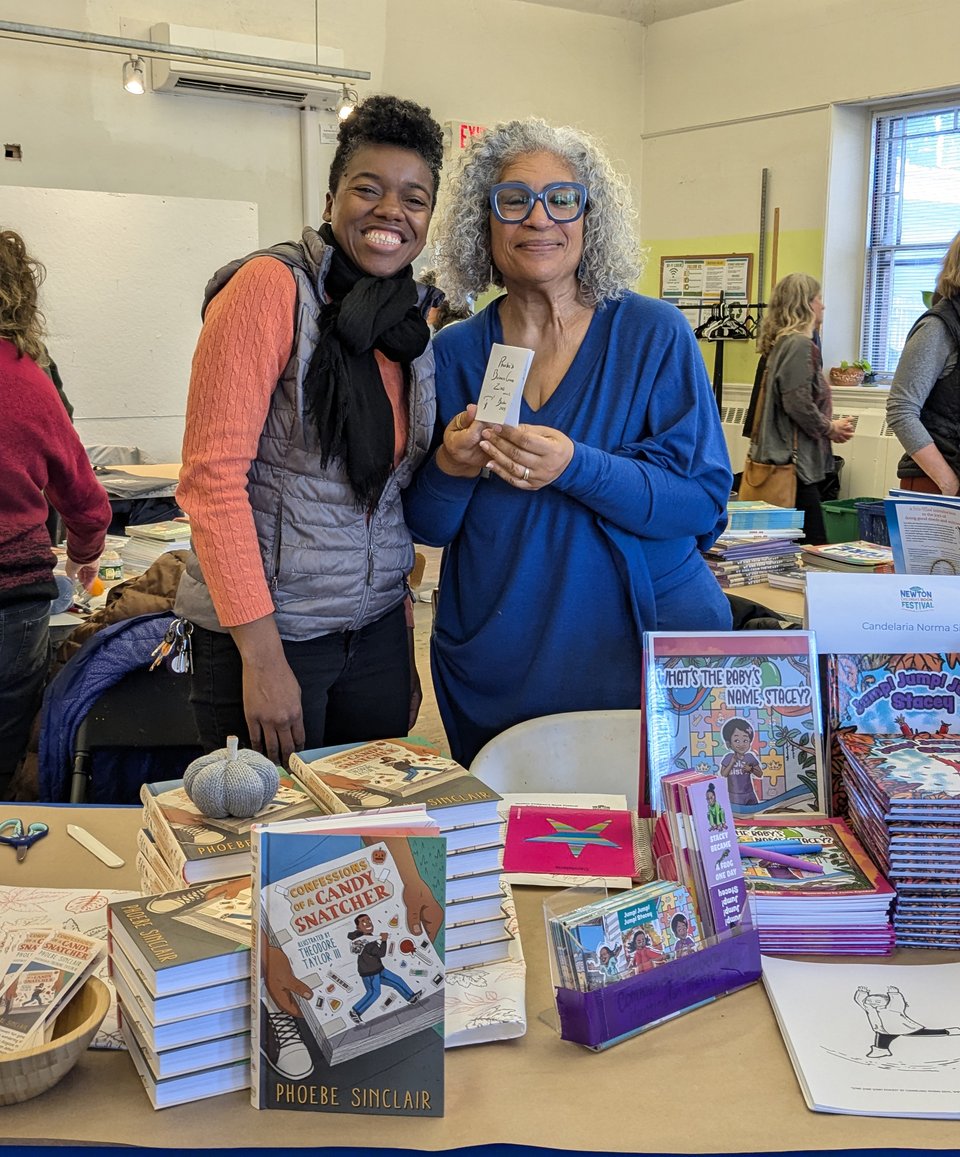 Two authors share a table at a book festival