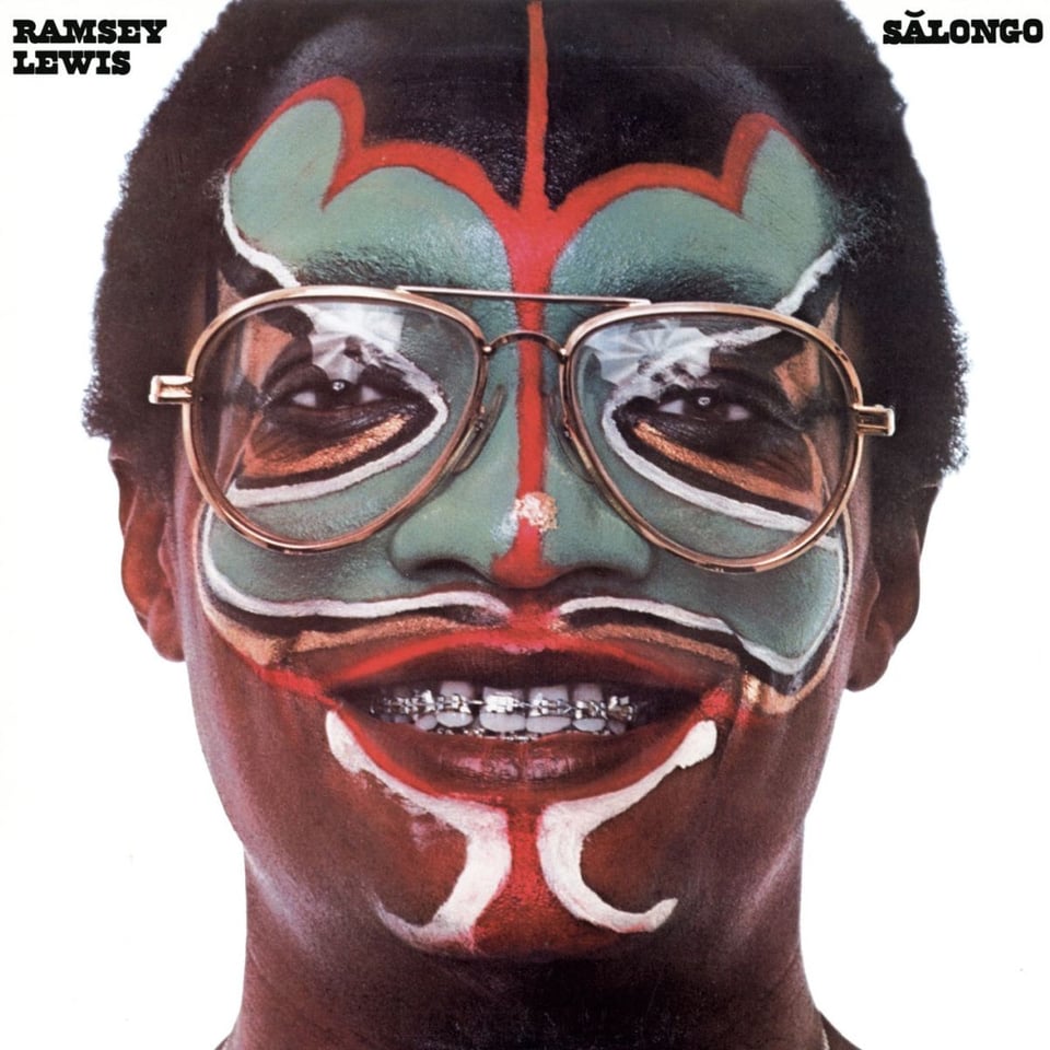 Ramsey Lewis has green, red and white face paint, plus braces on his teeth