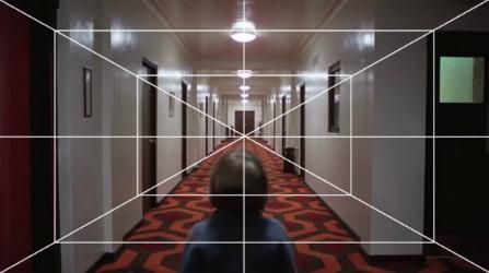 A one-point perspective grid overlaid a shot of Danny riding his bike over the carpet from hell.