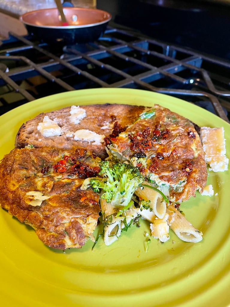 Omelette, toast and pasta on an avocado green plate