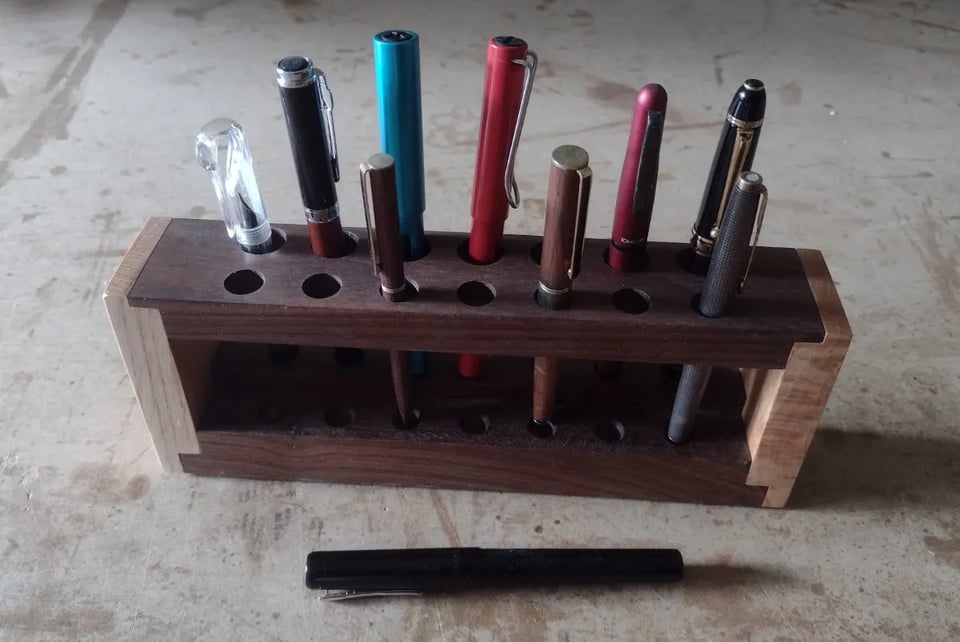 Pen rack with various fountain and other pens