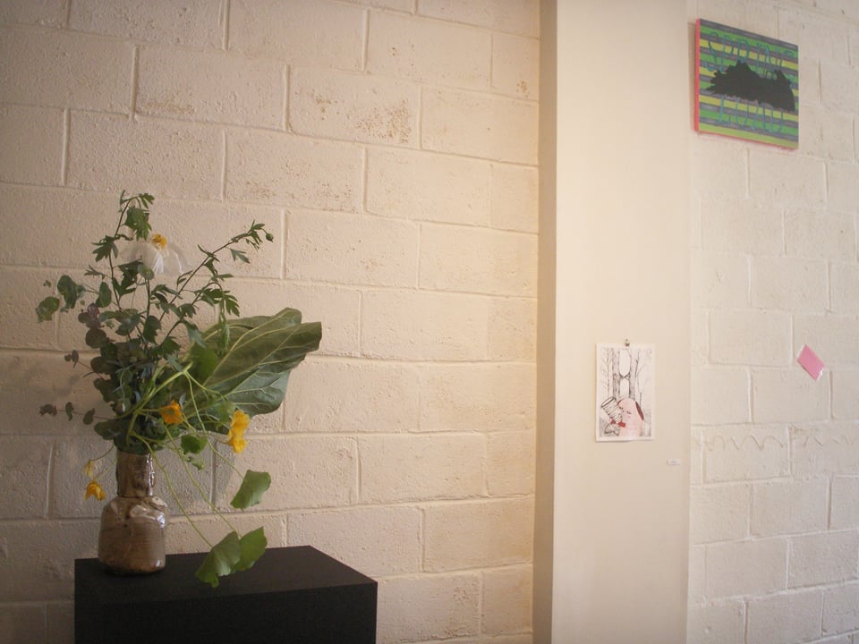 A bouquet of Matilija poppy, rhubarb lefa, nasturtium, and spiral eucalyptus alongside work by other artists at "Respond to Tree," curated by Robin Milliken at the Oakland gallery Confloptus.