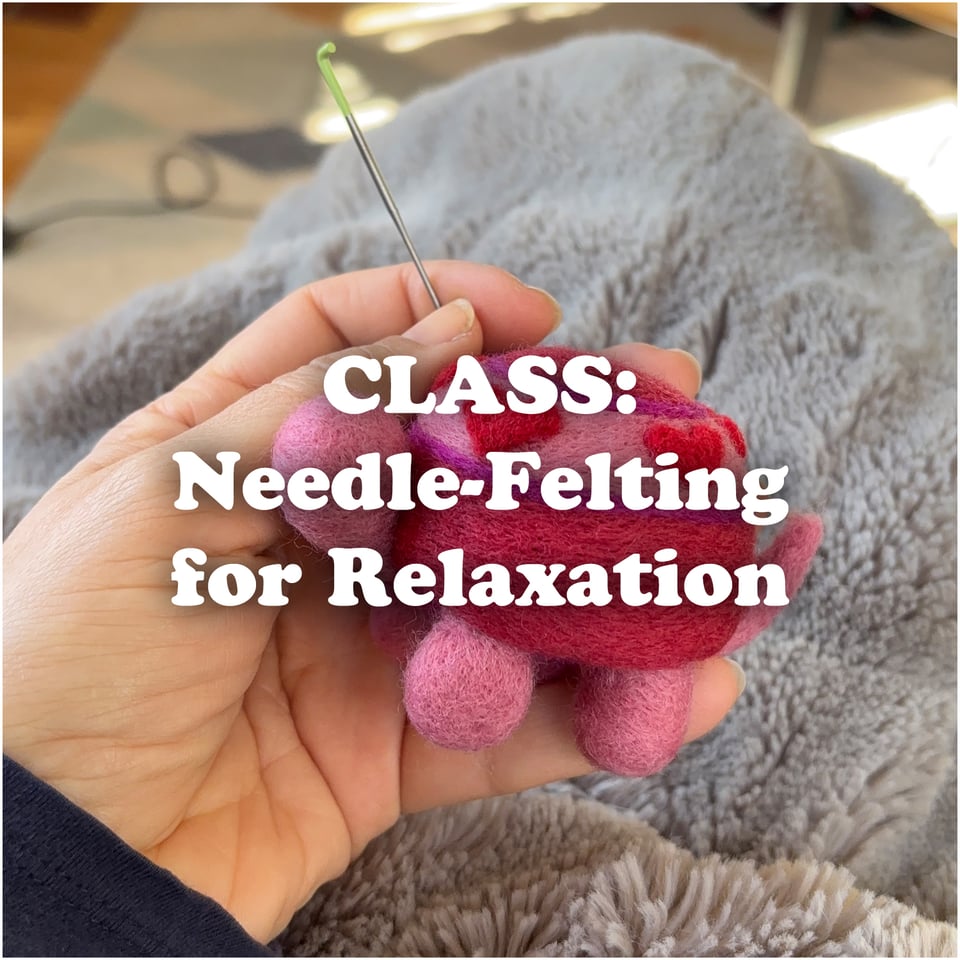 a hand holding a needle-felted turtle with a needle in it