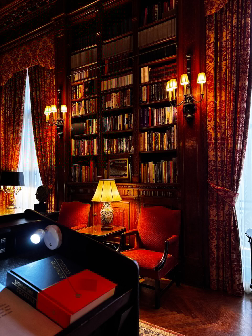 book SIGNATURE COCKTAILS by Amanda Schuster resting on the podium in the opulent library of the Lotos Club, New York City