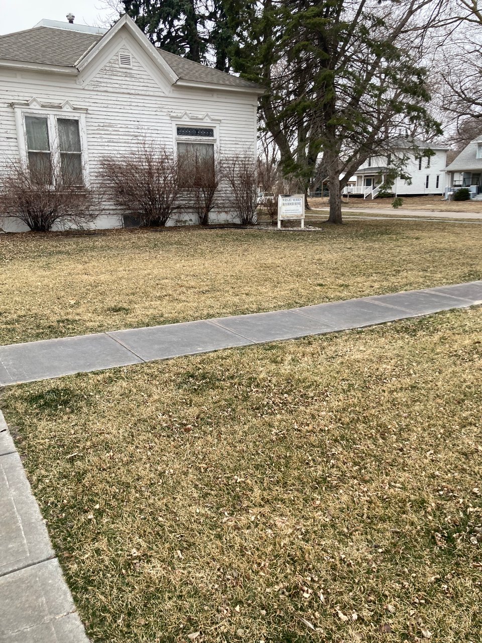 An image of Wright Morris's boyhood home, a small peeling white house in Central City, Nebraska