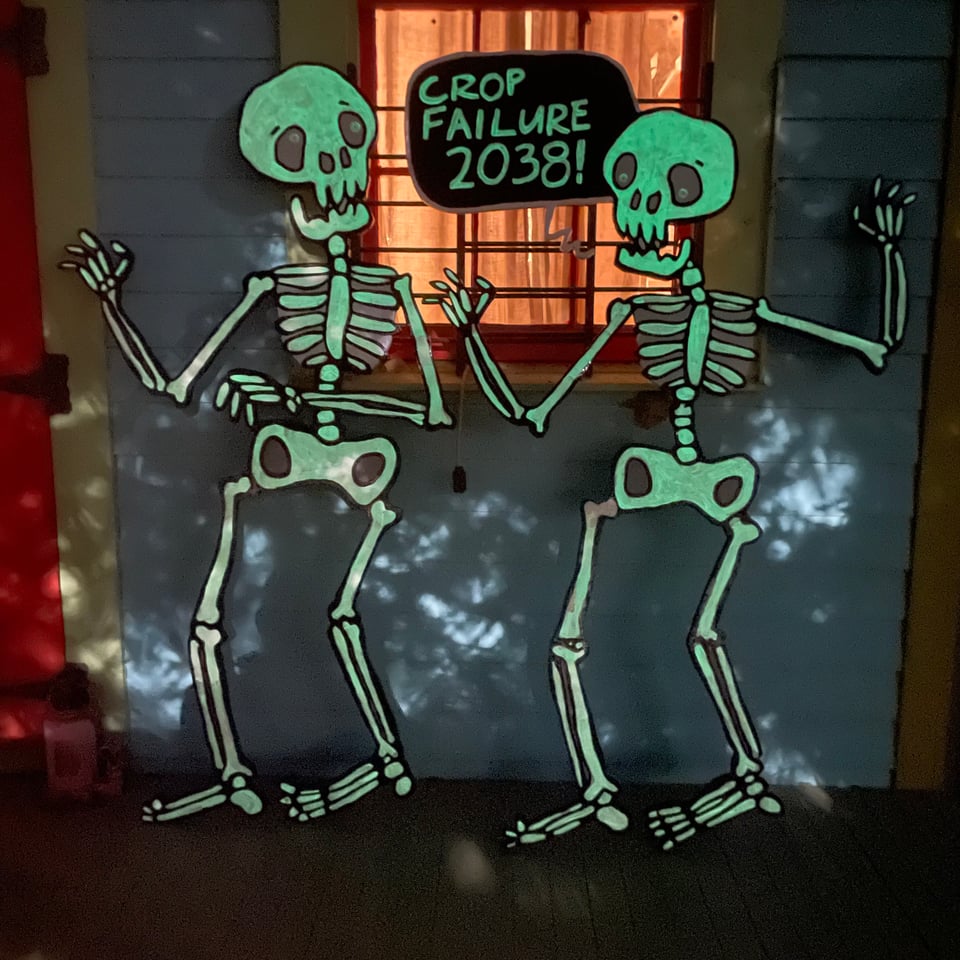 same painting of two skeletons, but glowing in the dark