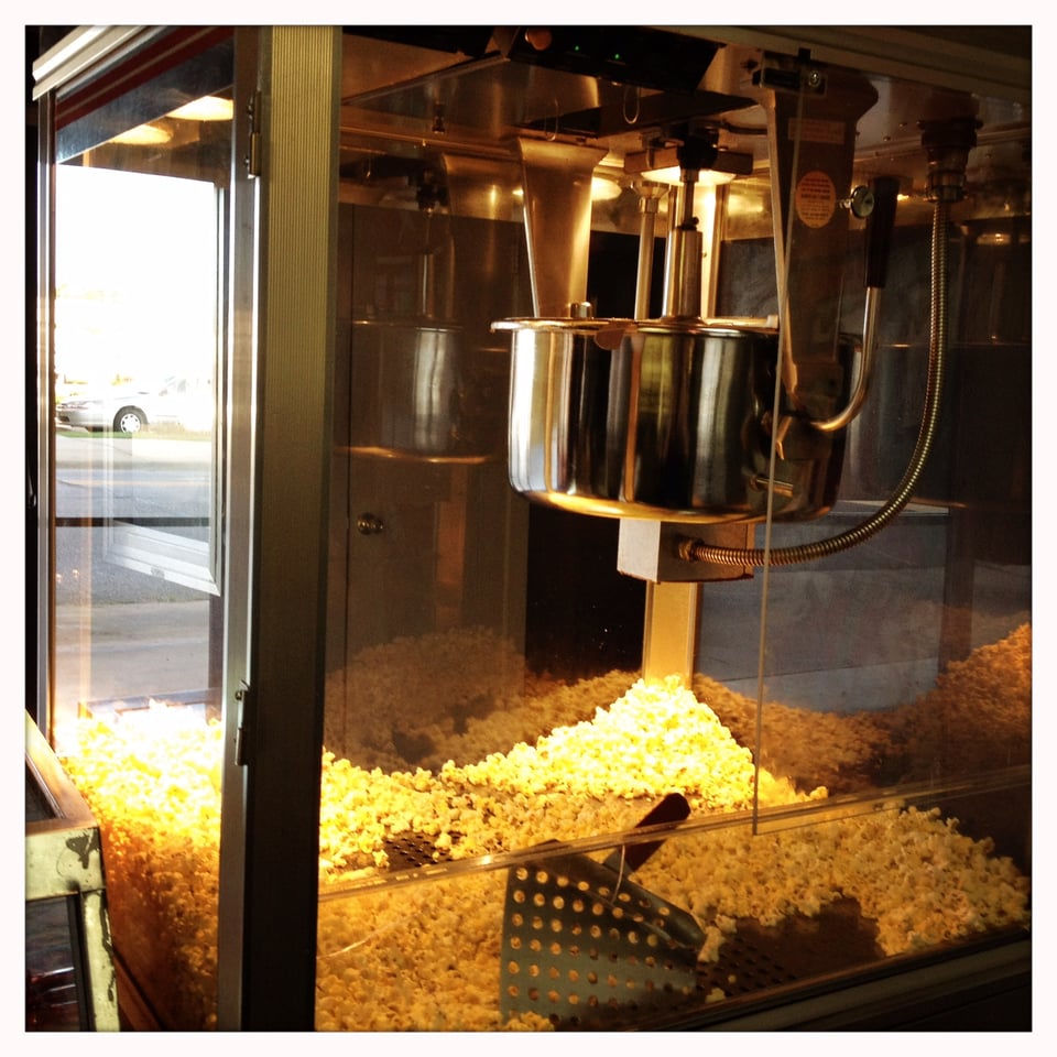 The popcorn machine from the Cameo with a light layer of popcorn.